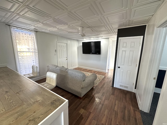 unfurnished living room with dark wood-style floors, an ornate ceiling, visible vents, and baseboards