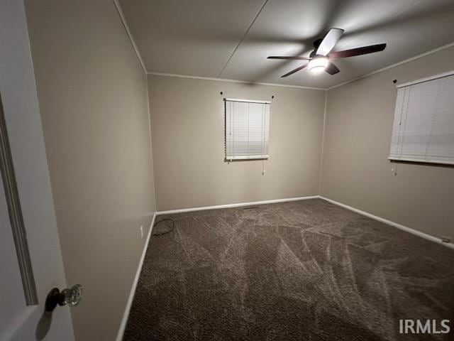 empty room with ceiling fan, carpet floors, and ornamental molding