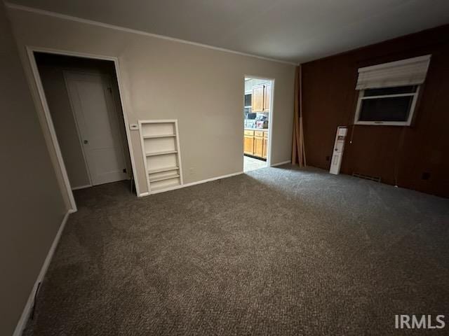 carpeted spare room with built in shelves