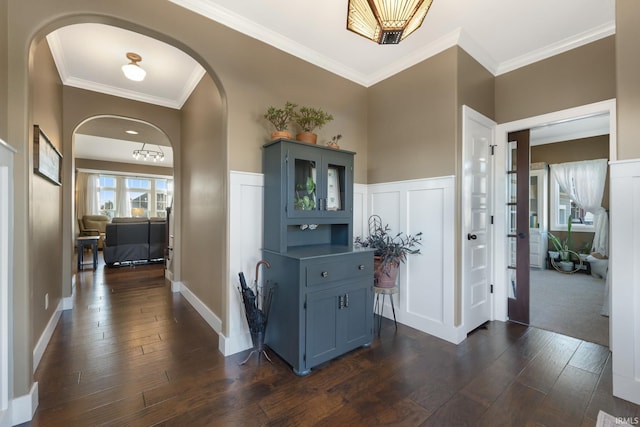 hallway with dark hardwood / wood-style floors and ornamental molding