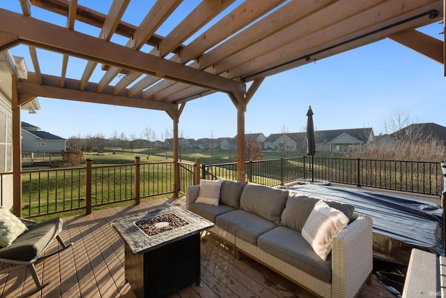 deck featuring a yard, a pergola, and an outdoor living space with a fire pit