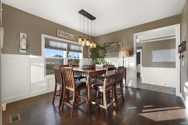 dining room featuring a notable chandelier and dark wood-type flooring