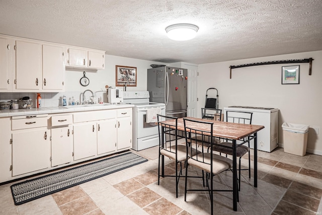 kitchen featuring white cabinets, sink, a textured ceiling, fridge, and white electric range oven