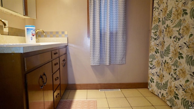 bathroom with tile patterned flooring and vanity