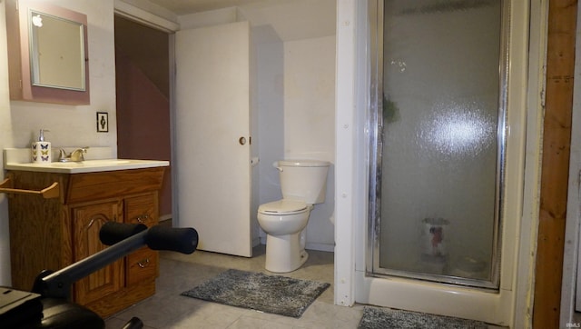 bathroom with tile patterned floors, vanity, toilet, and walk in shower