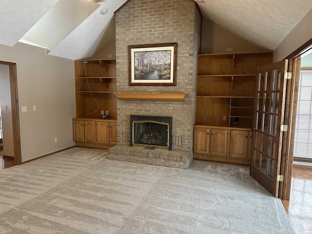 unfurnished living room with vaulted ceiling, built in features, a fireplace, and a textured ceiling