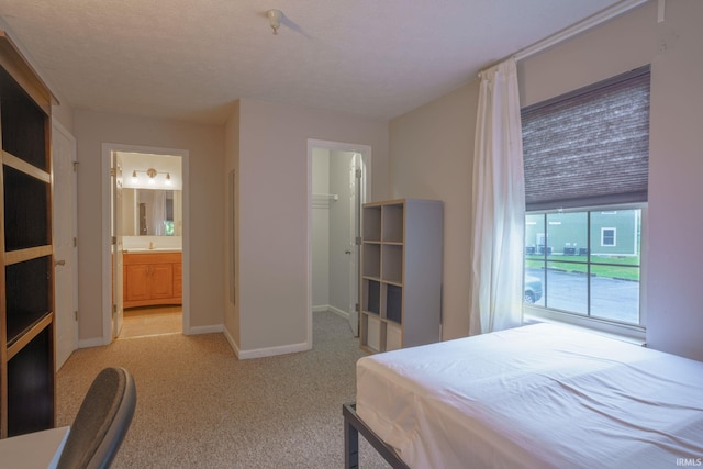 carpeted bedroom with ensuite bathroom