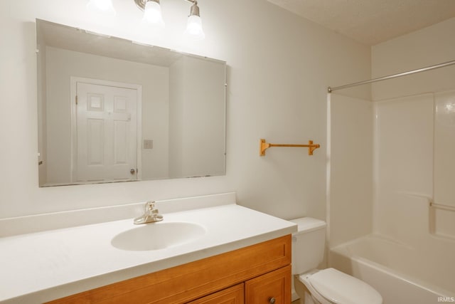 full bathroom featuring vanity, toilet, a textured ceiling, and bathing tub / shower combination