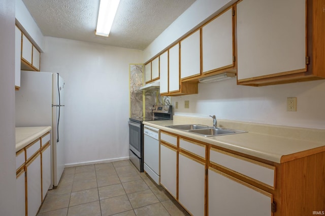 kitchen with a textured ceiling, white cabinetry, sink, and white appliances