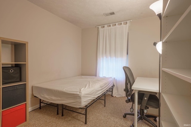 bedroom with carpet flooring and a textured ceiling