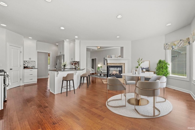 living room with hardwood / wood-style floors and sink