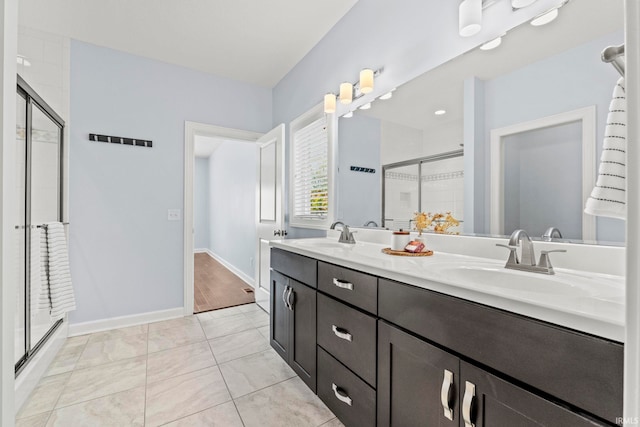 bathroom featuring tile patterned flooring, vanity, and an enclosed shower