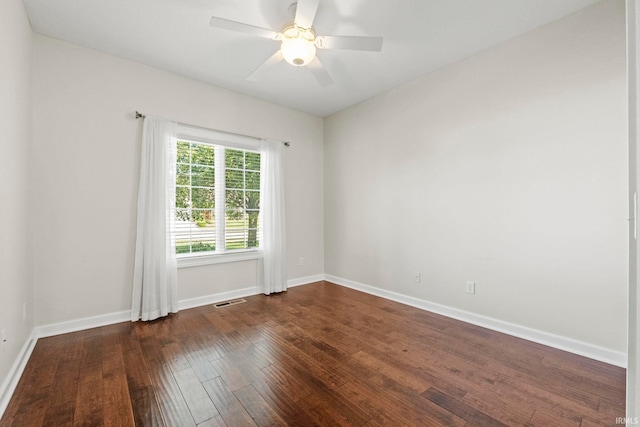 spare room with ceiling fan and dark hardwood / wood-style flooring