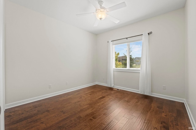 spare room with ceiling fan and dark hardwood / wood-style flooring