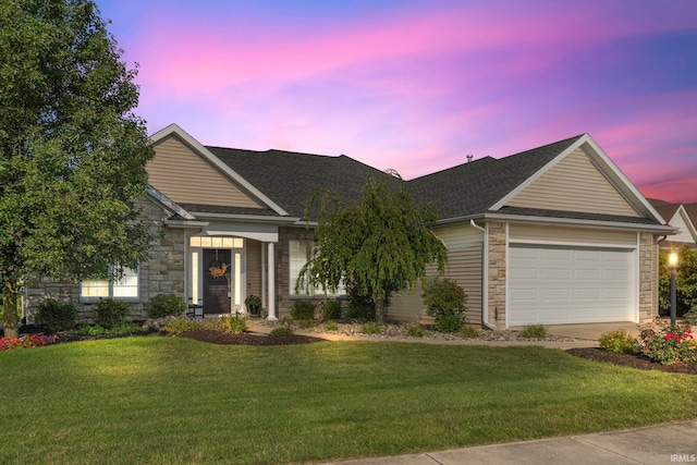 view of front of home featuring a garage and a lawn