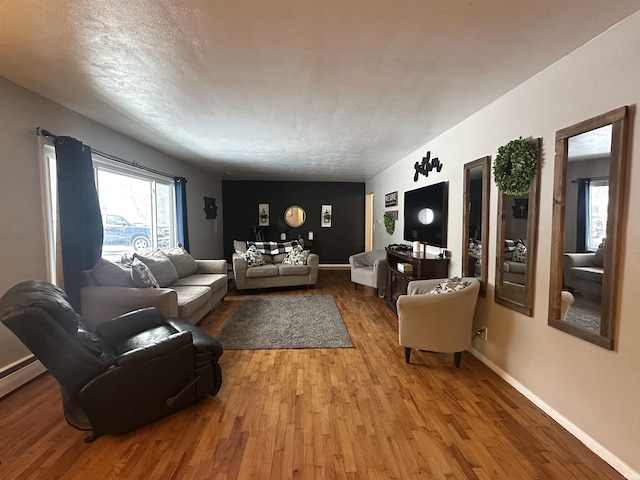 living room with wood-type flooring and a textured ceiling