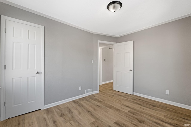 unfurnished bedroom with light wood-type flooring