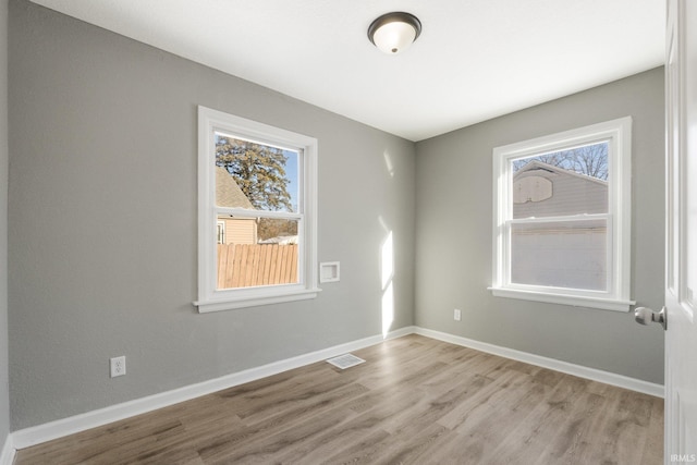 spare room with light wood-type flooring