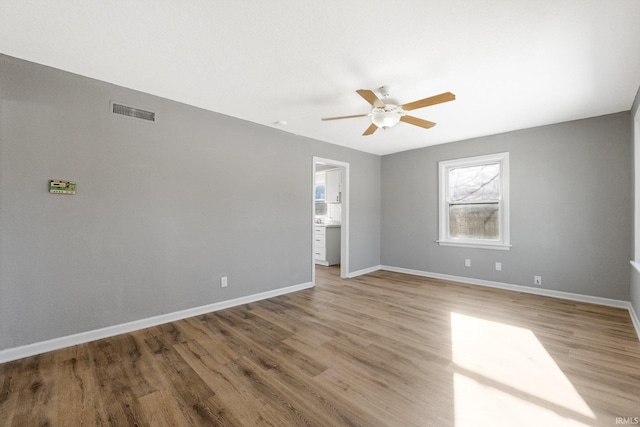 unfurnished room featuring hardwood / wood-style flooring and ceiling fan