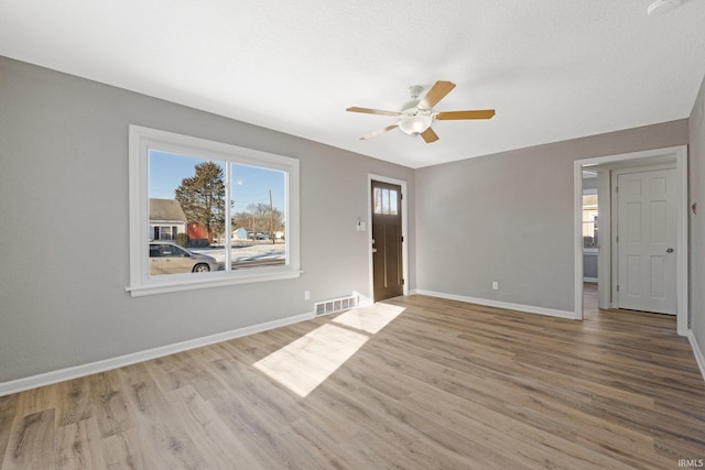 unfurnished room featuring ceiling fan and light wood-type flooring