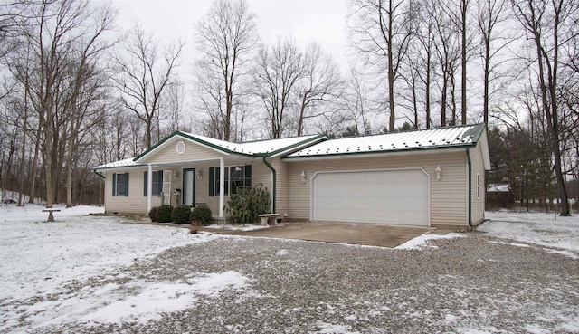 single story home featuring covered porch and a garage