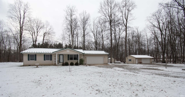 view of front of property featuring a garage and an outdoor structure