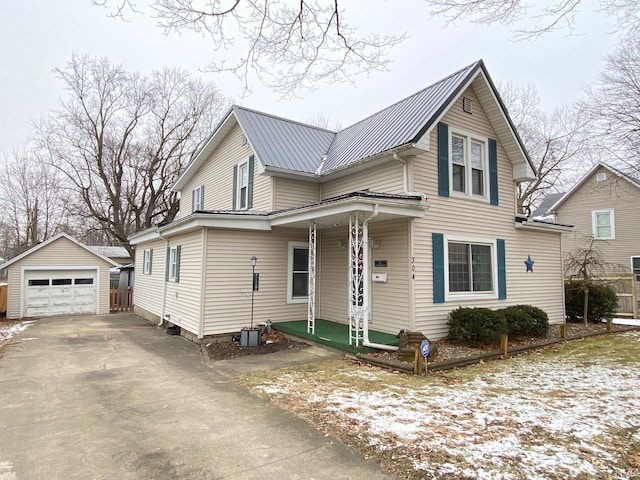 view of front of home with a garage and an outdoor structure