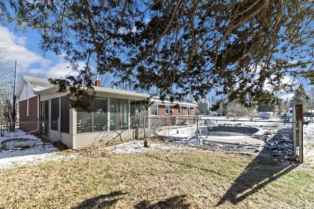 view of yard with fence and a sunroom