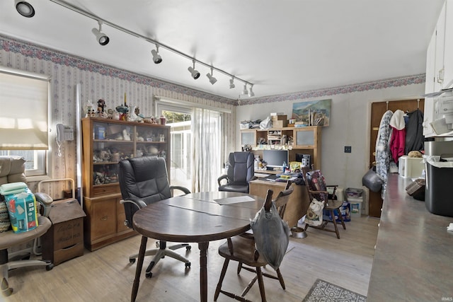 office space with light wood-type flooring and wallpapered walls