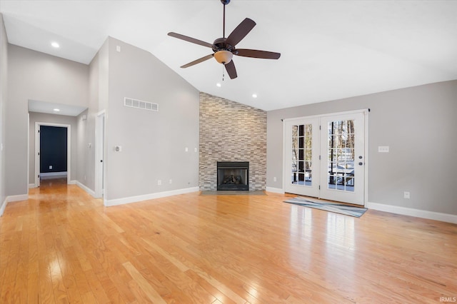 unfurnished living room featuring a fireplace, light wood-type flooring, high vaulted ceiling, and ceiling fan