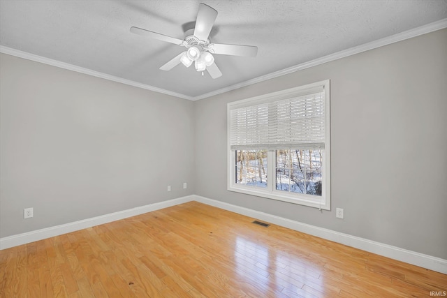 empty room with a textured ceiling, light hardwood / wood-style flooring, ceiling fan, and crown molding