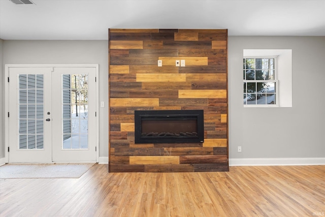 living room featuring french doors and light hardwood / wood-style flooring