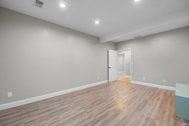 spare room featuring light wood-type flooring