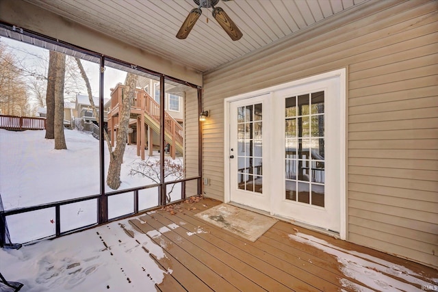 unfurnished sunroom featuring ceiling fan, wooden ceiling, and a wealth of natural light