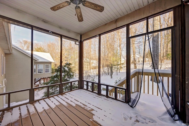 unfurnished sunroom with ceiling fan