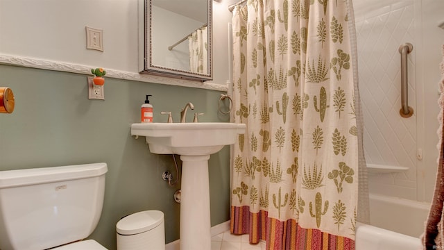 bathroom featuring tile patterned flooring, shower / bath combination with curtain, and toilet