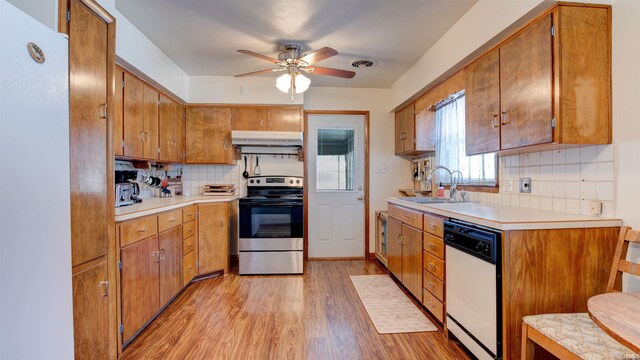 kitchen featuring dishwasher, sink, tasteful backsplash, and electric stove