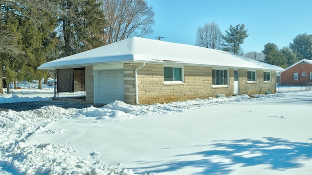 view of snow covered exterior featuring a garage