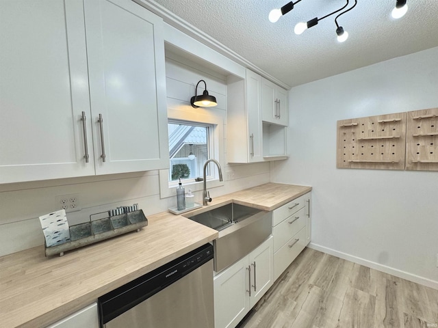 kitchen featuring white cabinetry, dishwasher, sink, light hardwood / wood-style flooring, and a textured ceiling