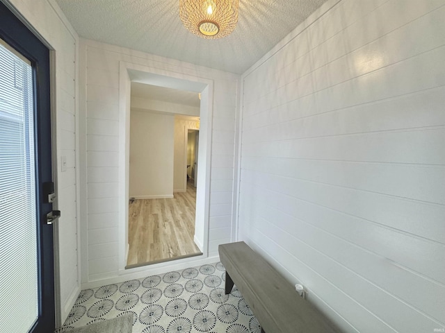 mudroom featuring a textured ceiling