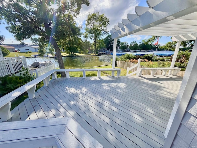 wooden terrace featuring a water view