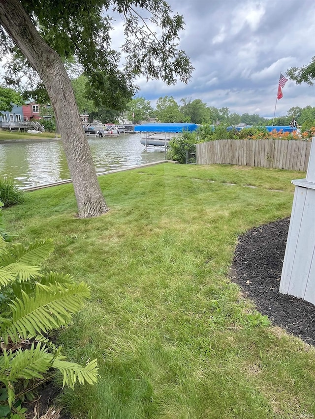 view of yard featuring a boat dock and a water view