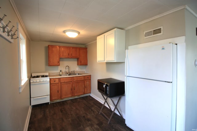 kitchen with white appliances, dark hardwood / wood-style floors, a wealth of natural light, and sink