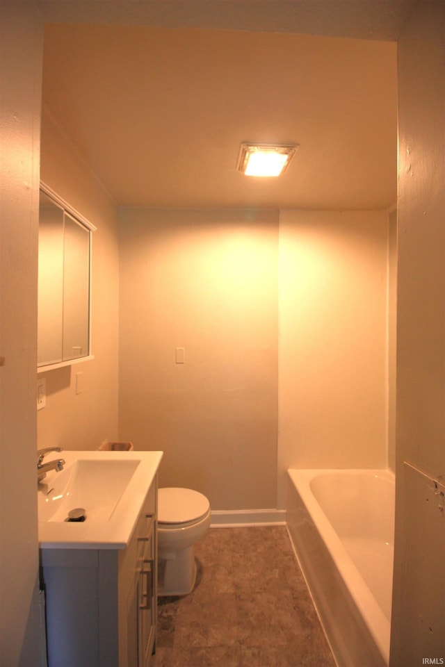 bathroom with vanity, toilet, and a tub