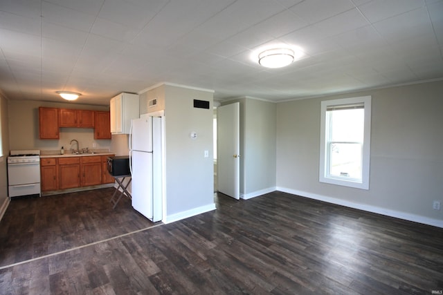 kitchen with crown molding, sink, white appliances, and dark wood-type flooring