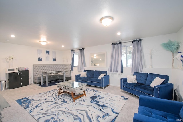 carpeted living room featuring plenty of natural light