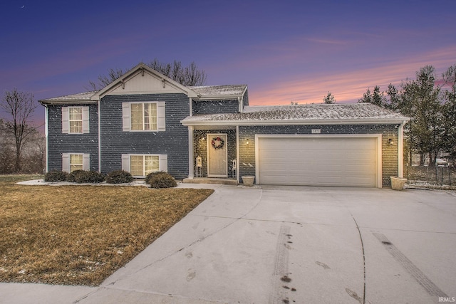 split level home with a lawn and a garage