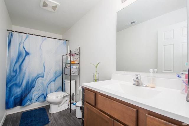 full bathroom featuring hardwood / wood-style flooring, vanity, toilet, and shower / tub combo with curtain