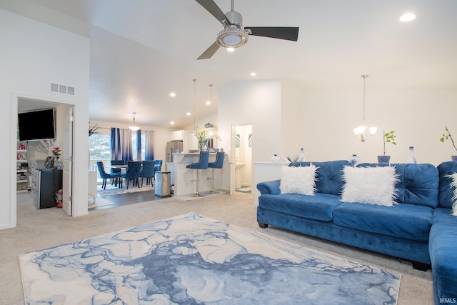 living room with ceiling fan with notable chandelier, light carpet, and high vaulted ceiling