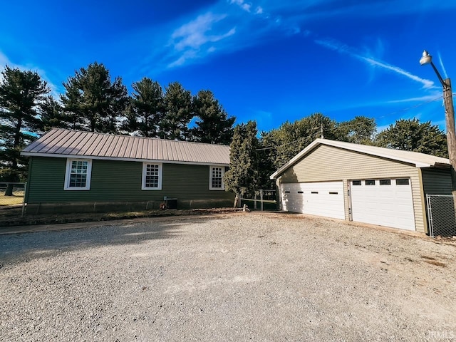 view of front of property with a garage and an outdoor structure